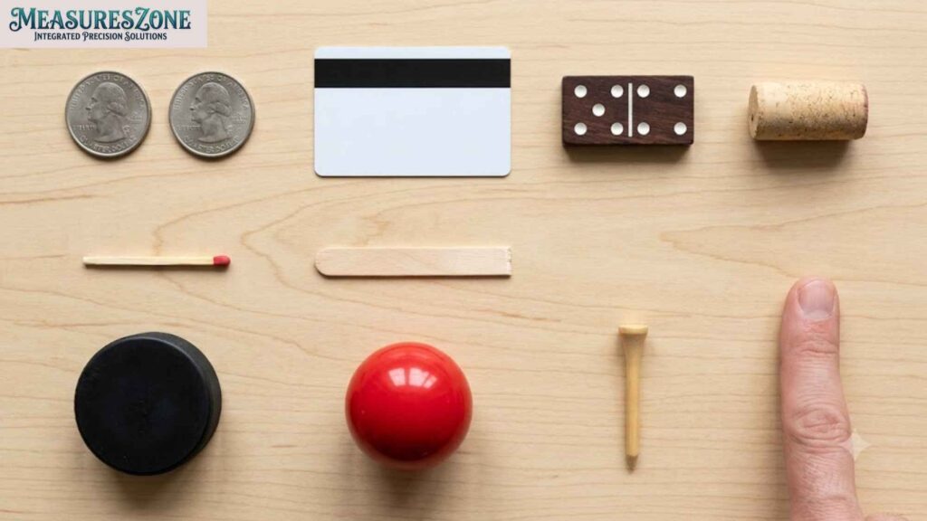 Flat lay of varied items on wood. Finger points upward on right.