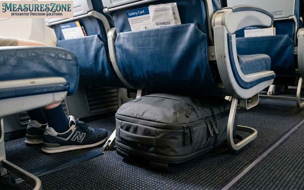 Dark gray backpack fitting under an airplane seat as an 18-inch personal item.